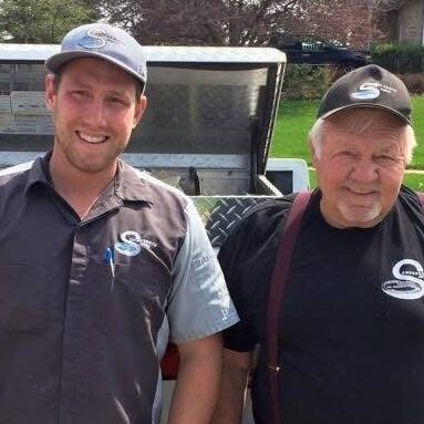 Zack Sondgeroth standing beside his grandfather, founder of Sondgeroth Pools, continuing the family legacy of pool building.